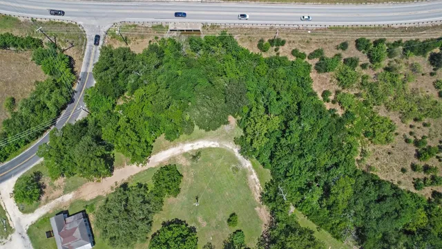 an aerial view of a residential houses with yard