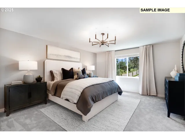 a spacious bedroom with a bed and a chandelier