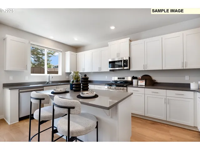 a kitchen with a sink cabinets and window