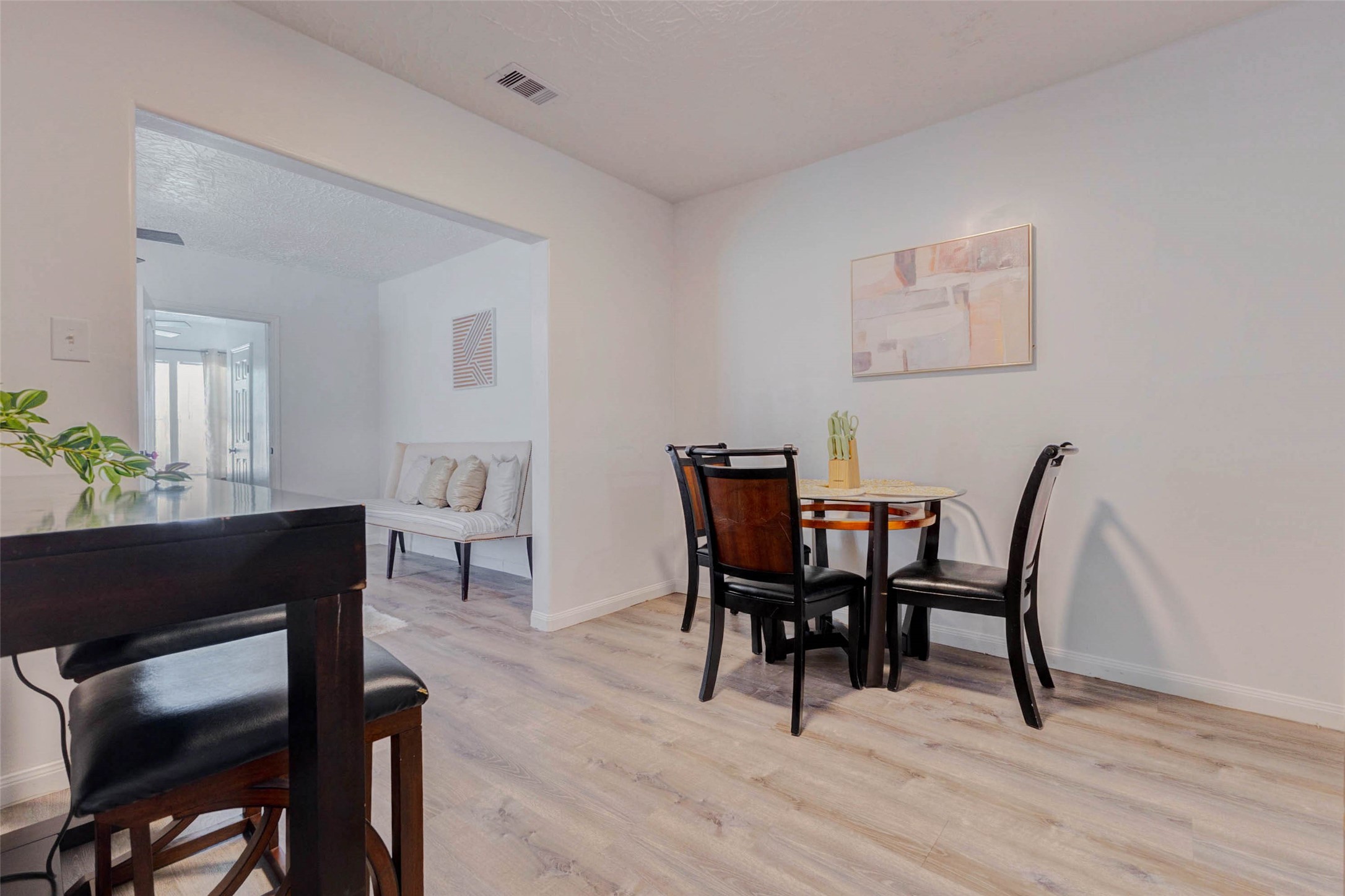 2902 Truxillo Street Houston, TX 77004 - Photo 15 of 32 a view of a dining room with furniture and wooden floor