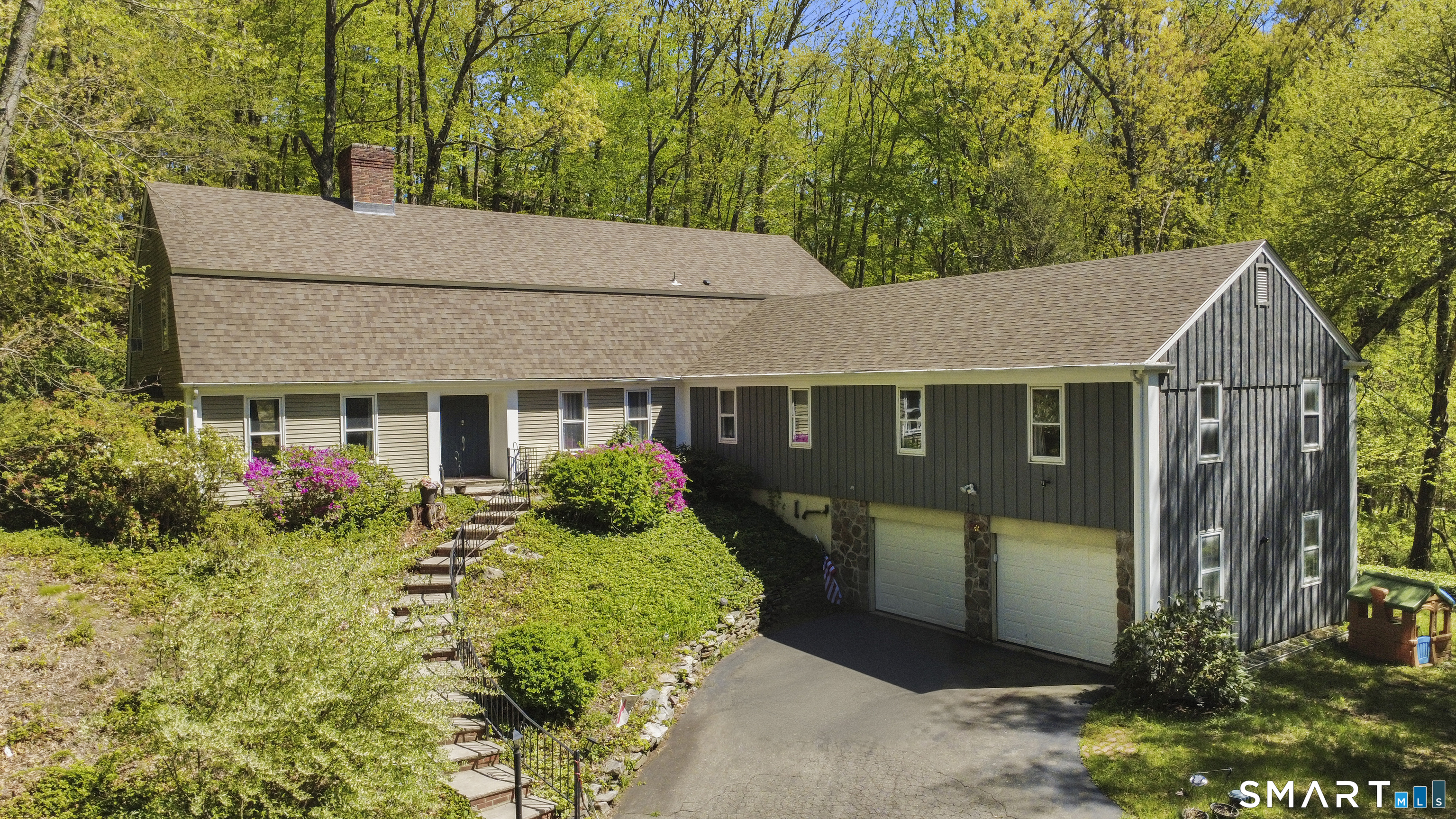 a front view of house with yard and trees in the background