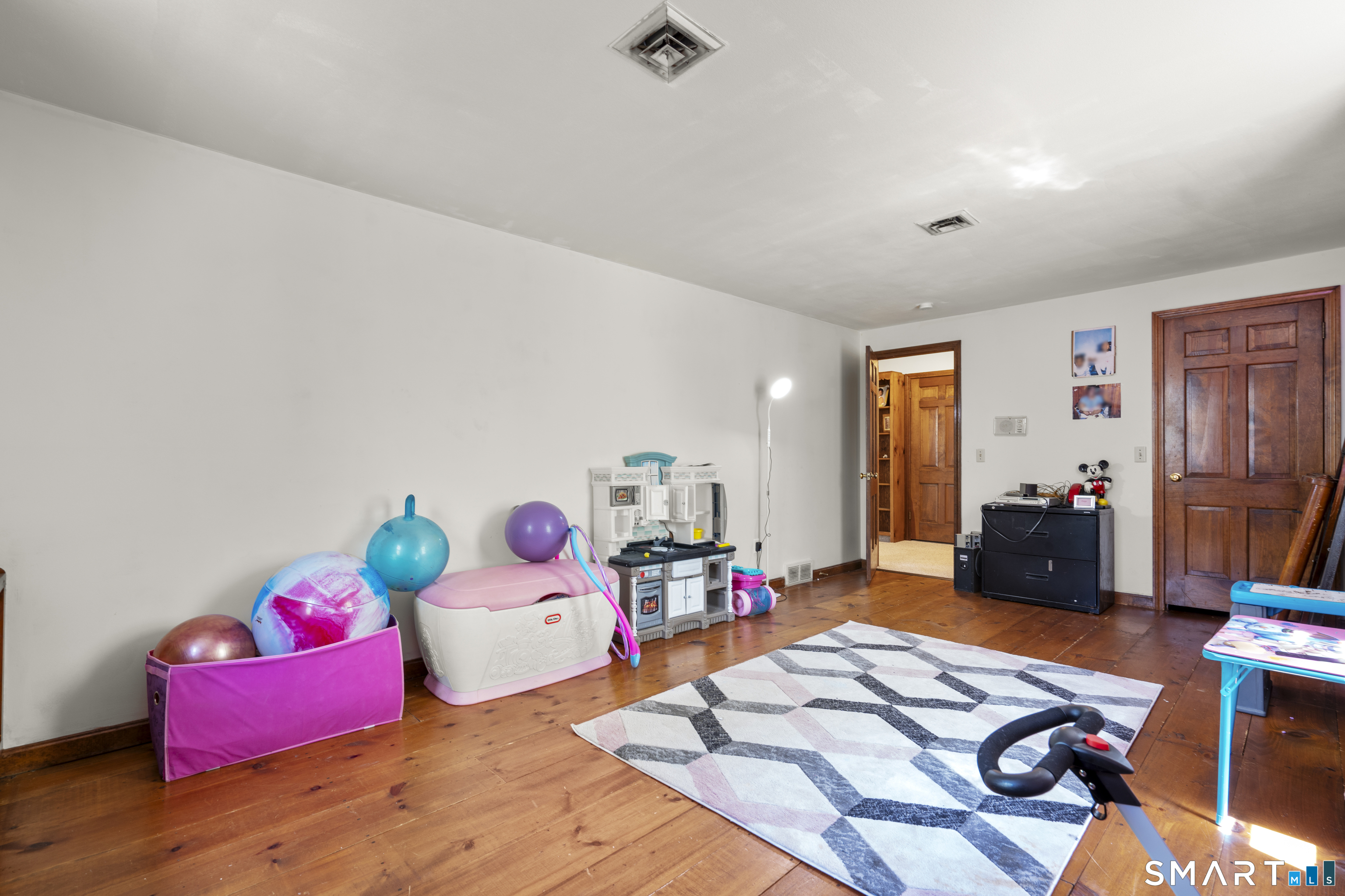 81 Meeting House Road Haddam, CT 06438 - Photo 19 of 35 a bedroom with furniture and a wooden floor