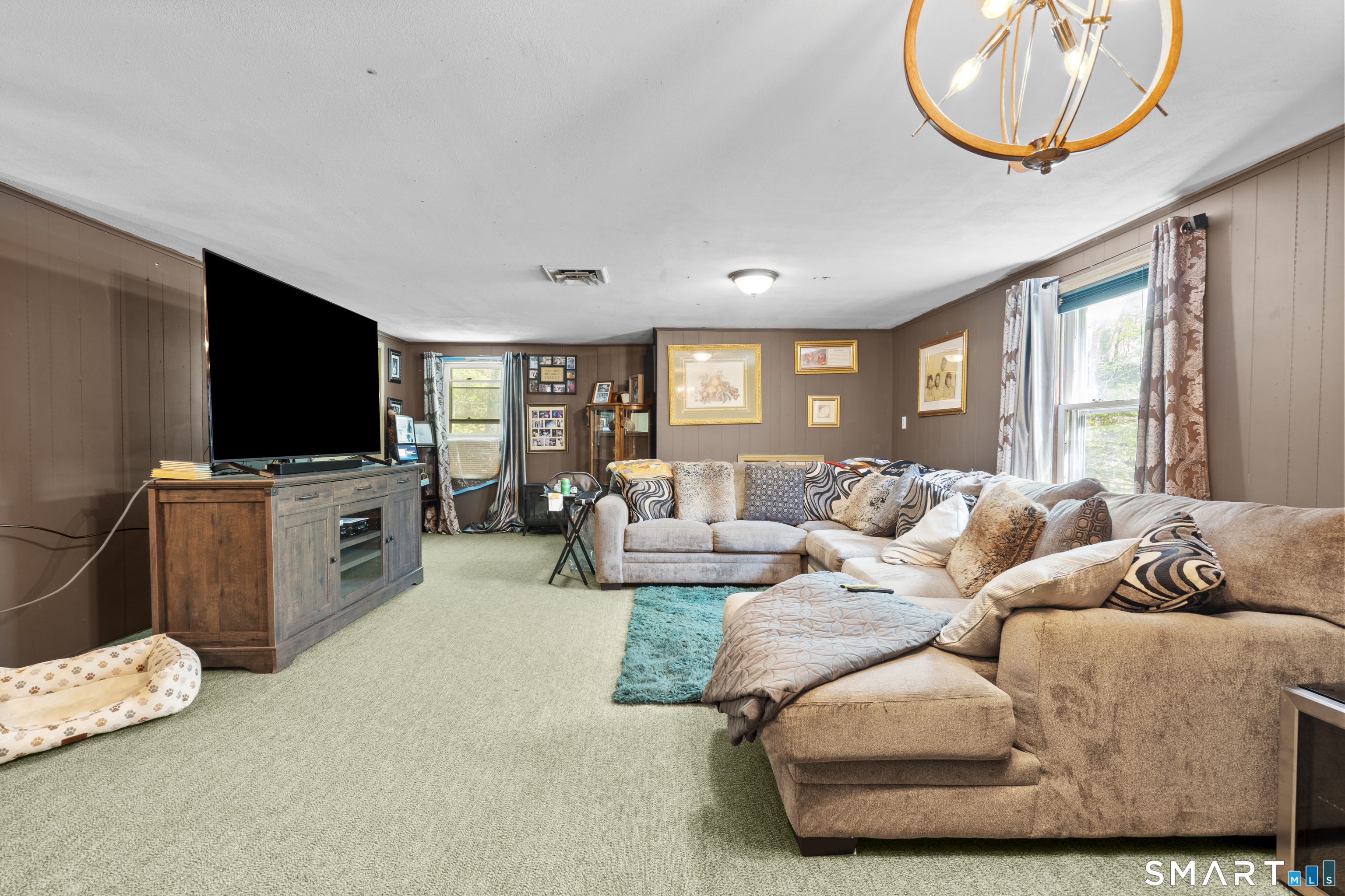 81 Meeting House Road Haddam, CT 06438 - Photo 22 of 35 a living room with furniture a flat screen tv and a window