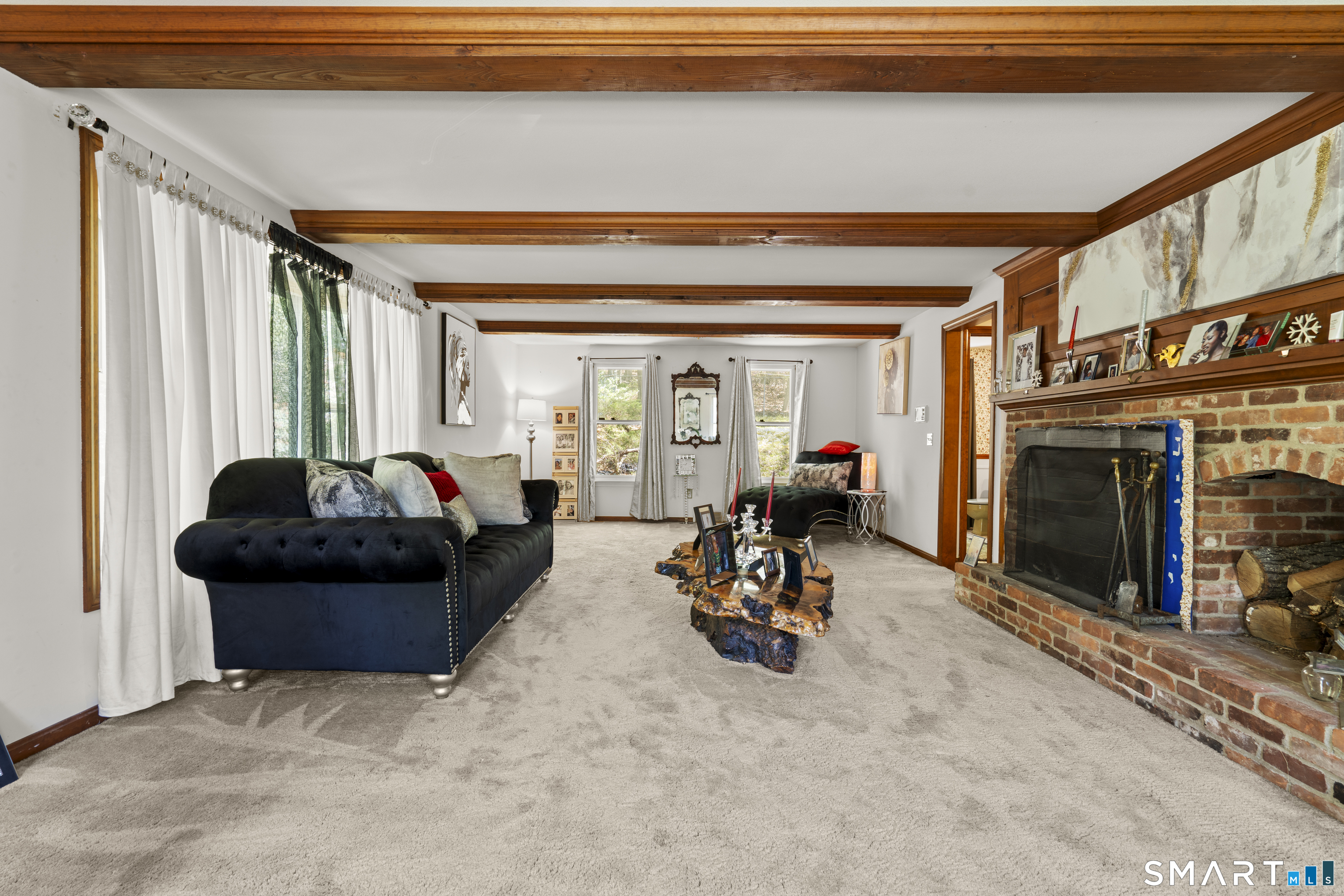81 Meeting House Road Haddam, CT 06438 - Photo 6 of 35 a living room with furniture a fireplace and gym equipment