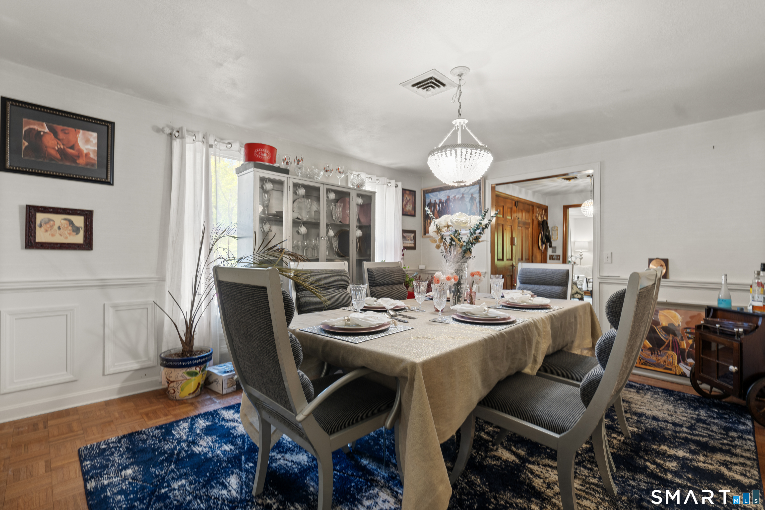 81 Meeting House Road Haddam, CT 06438 - Photo 8 of 35 a dining room with furniture a rug a potted plant and a chandelier