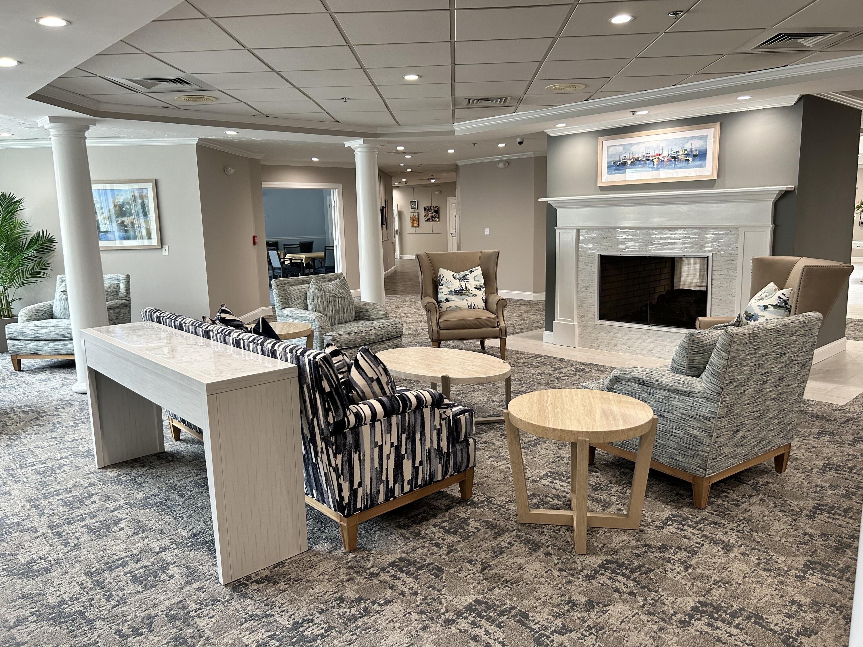 28 Windward Street, Unit 28 Mashpee, MA 02649 - Photo 21 of 37 a living room with furniture a fireplace and a table
