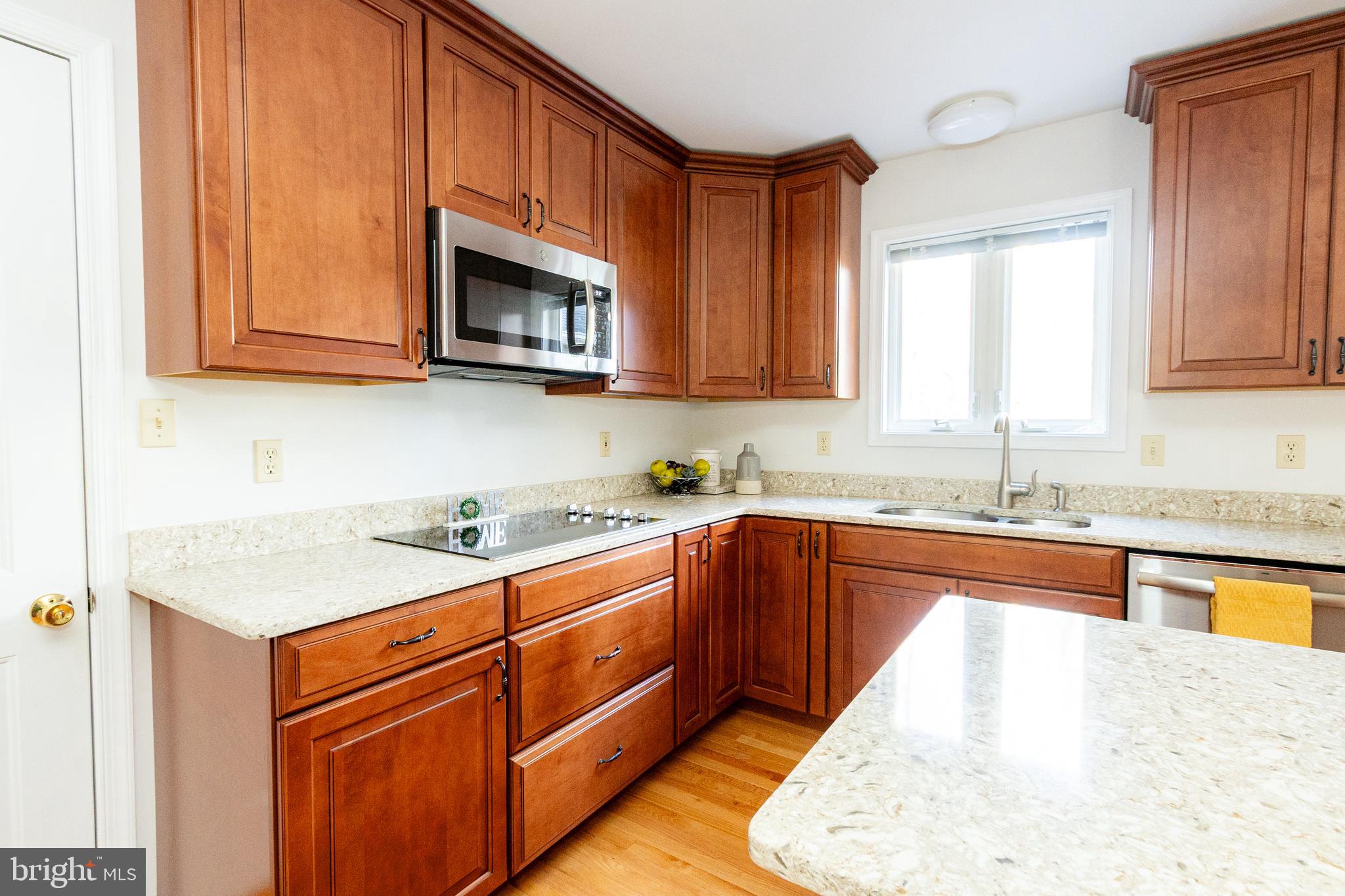 20753 Chestnut Ridge Drive Leonardtown, MD 20650 - Photo 13 of 45 a kitchen with stainless steel appliances granite countertop a sink stove and microwave