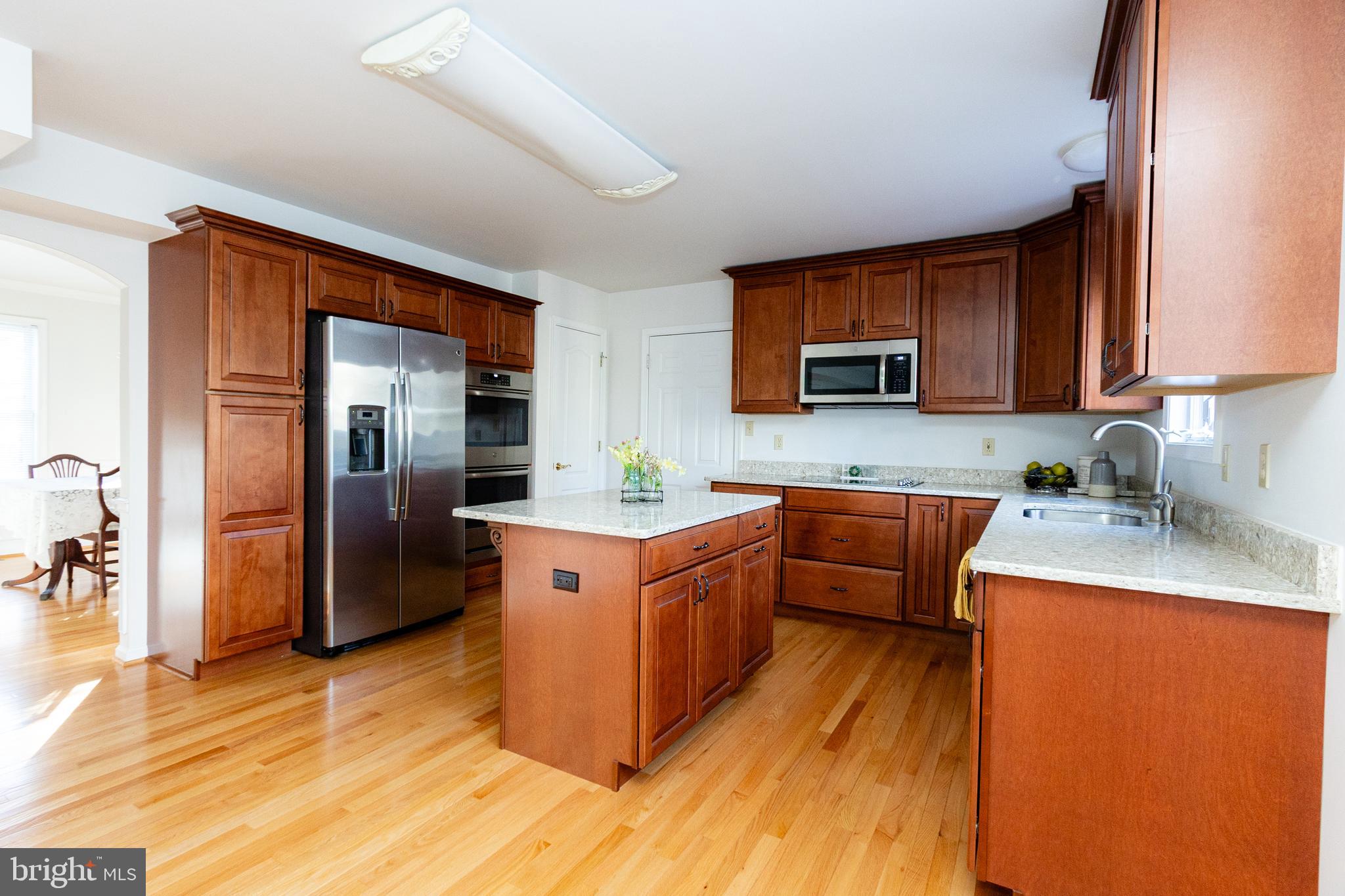 20753 Chestnut Ridge Drive Leonardtown, MD 20650 - Photo 15 of 45 a kitchen with stainless steel appliances granite countertop a refrigerator a stove top oven a sink and dishwasher