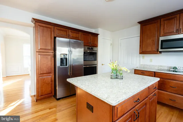 a bedroom with a bed and dresser with mirror