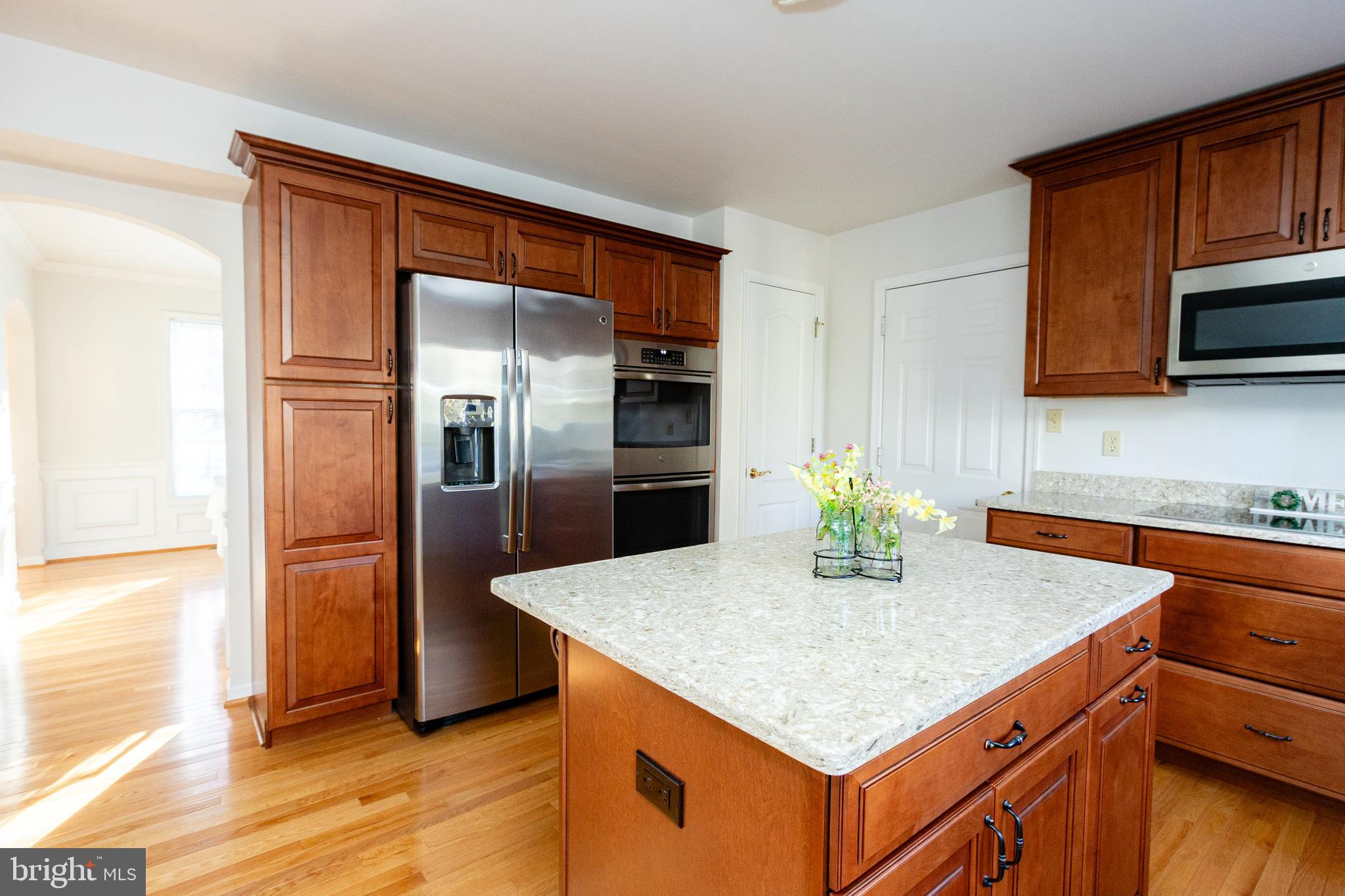 20753 Chestnut Ridge Drive Leonardtown, MD 20650 - Photo 16 of 45 a kitchen with stainless steel appliances granite countertop a kitchen island a stove a refrigerator a sink and a microwave