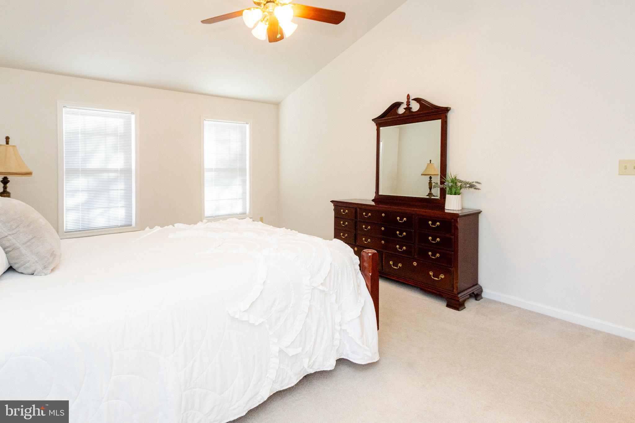 20753 Chestnut Ridge Drive Leonardtown, MD 20650 - Photo 28 of 45 a bedroom with a bed and dresser with mirror