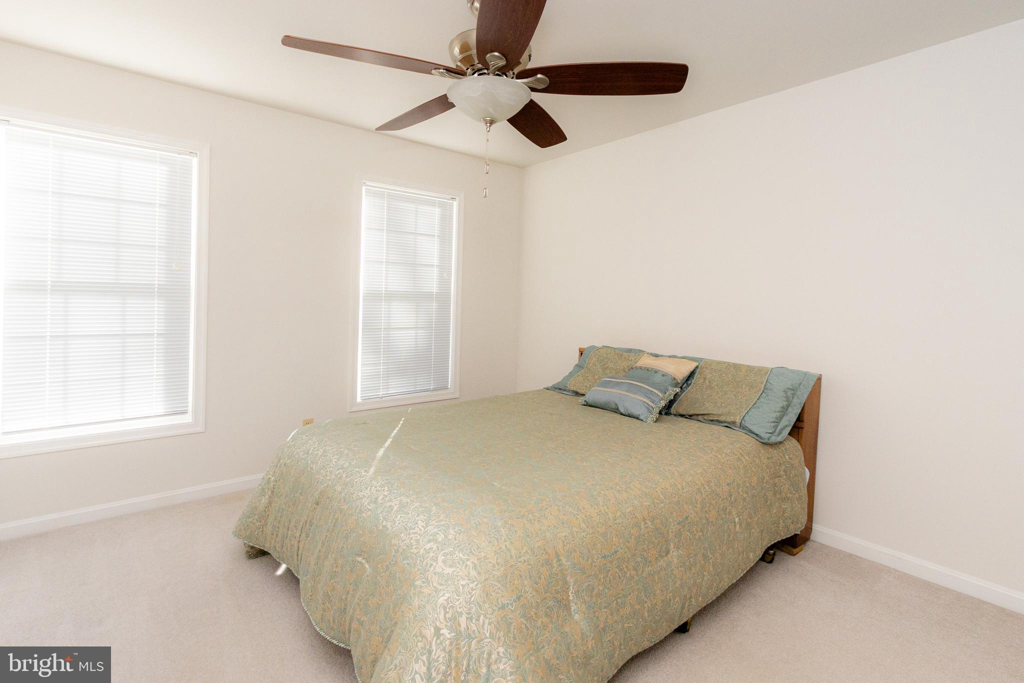 20753 Chestnut Ridge Drive Leonardtown, MD 20650 - Photo 36 of 45 a large bed sitting in a bedroom next to a window