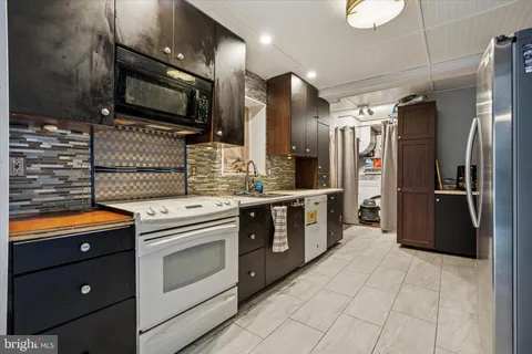a kitchen with stainless steel appliances a stove sink and refrigerator