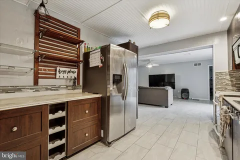 a kitchen with stainless steel appliances granite countertop a refrigerator and a stove