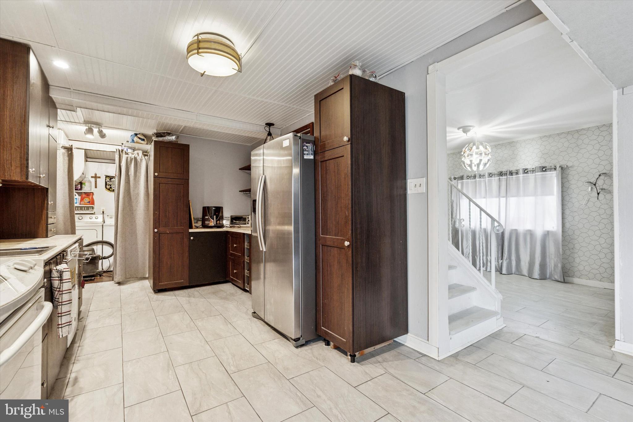 619 1st Avenue Croydon, PA 19021 - Photo 5 of 18 a view of a refrigerator in kitchen and a living room