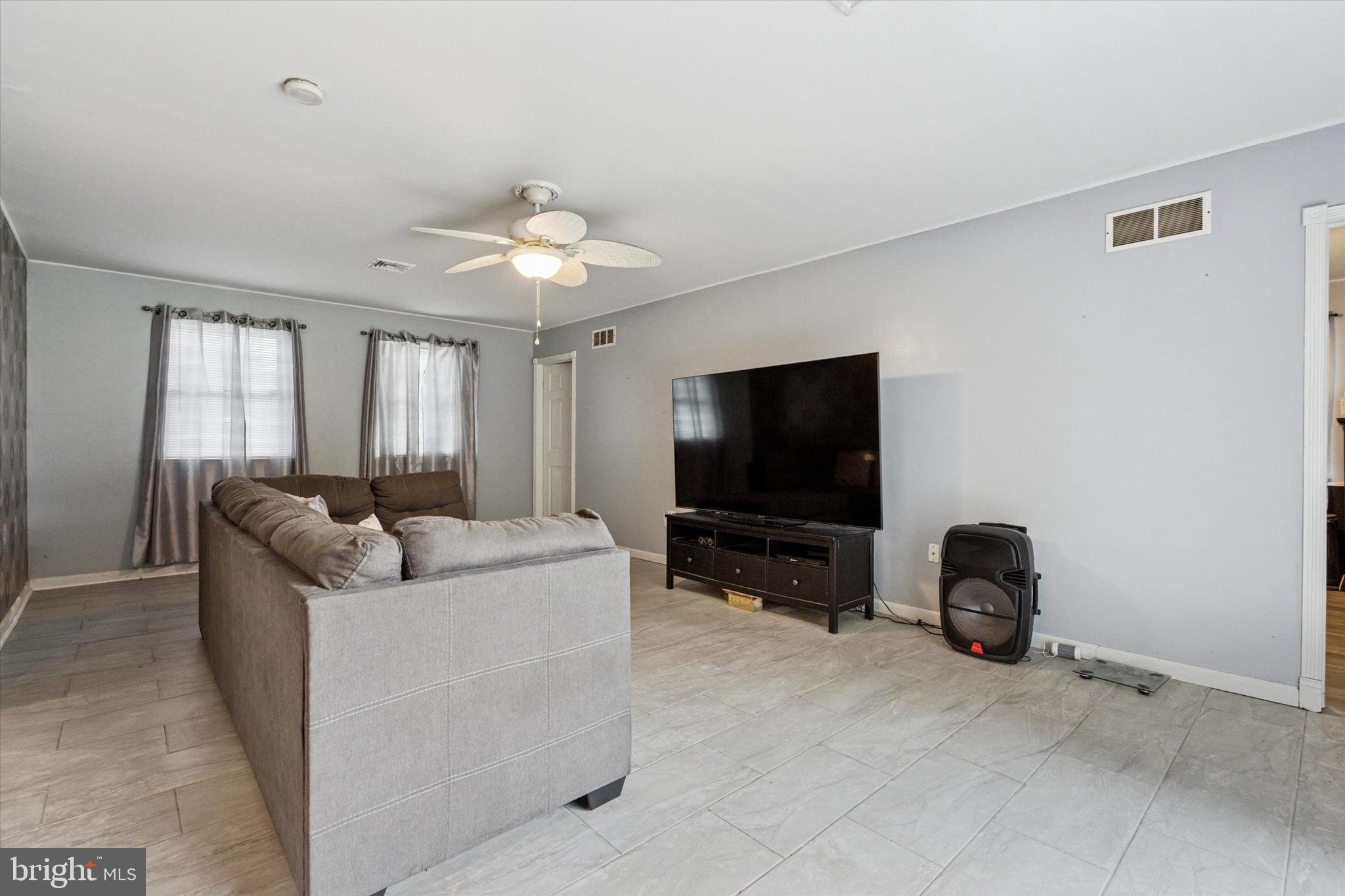 619 1st Avenue Croydon, PA 19021 - Photo 6 of 18 a living room with furniture and a flat screen tv