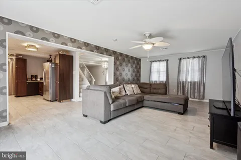a living room with furniture and a chandelier