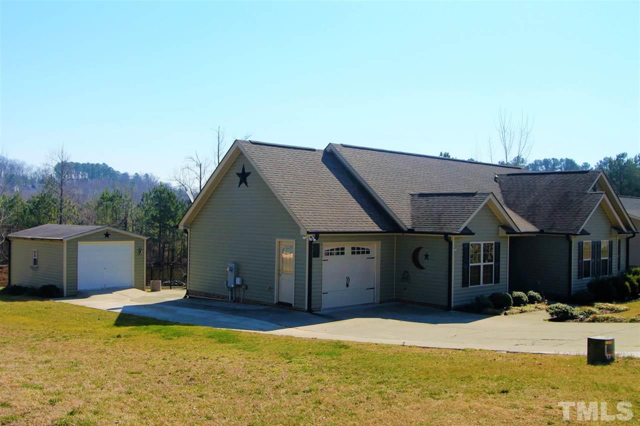 203 Orkney Road Stem, NC 27581 - Photo 2 of 30 a house view with a swimming pool in front of it