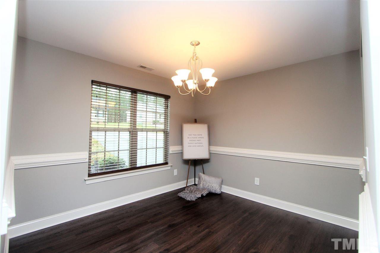 203 Orkney Road Stem, NC 27581 - Photo 13 of 30 a room with painting on the wall and a window