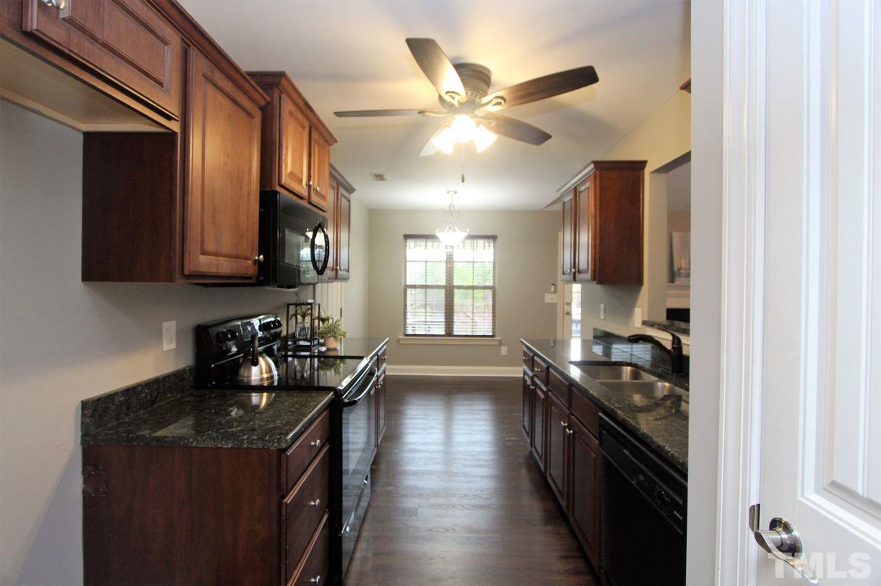203 Orkney Road Stem, NC 27581 - Photo 14 of 30 a kitchen with a stove window and cabinets