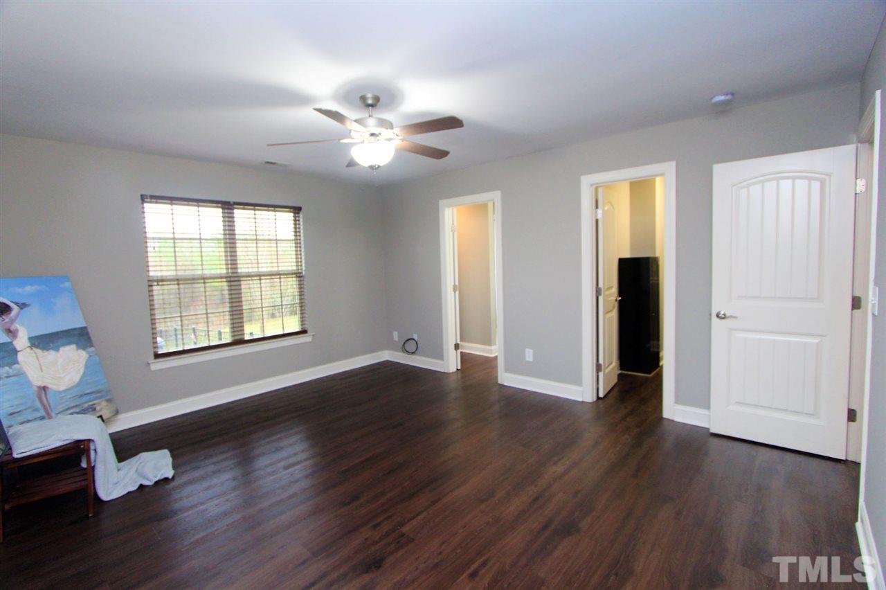 203 Orkney Road Stem, NC 27581 - Photo 15 of 30 a view of an empty room with wooden floor and a window