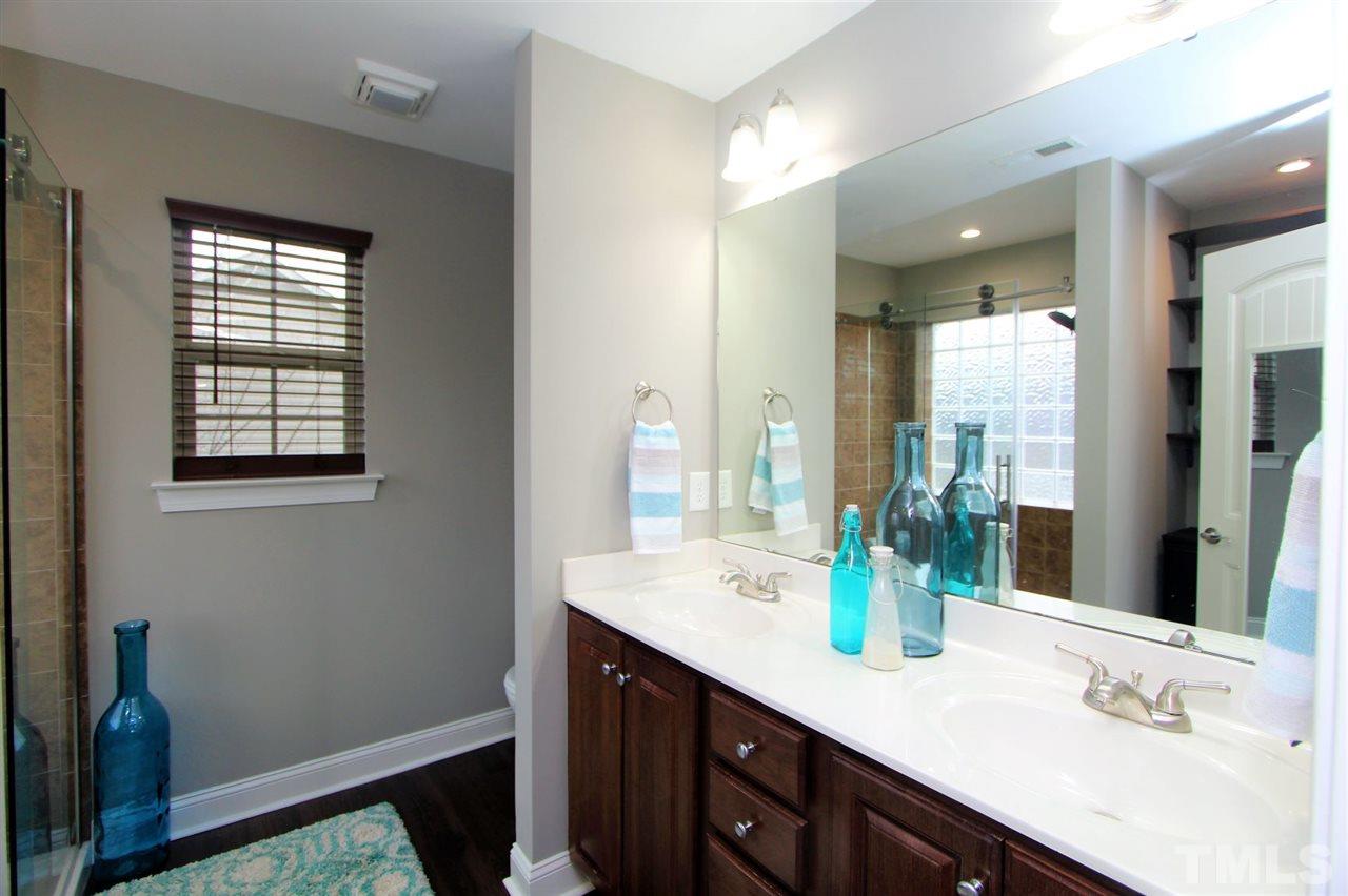 203 Orkney Road Stem, NC 27581 - Photo 17 of 30 a bathroom with a sink double vanity and a mirror