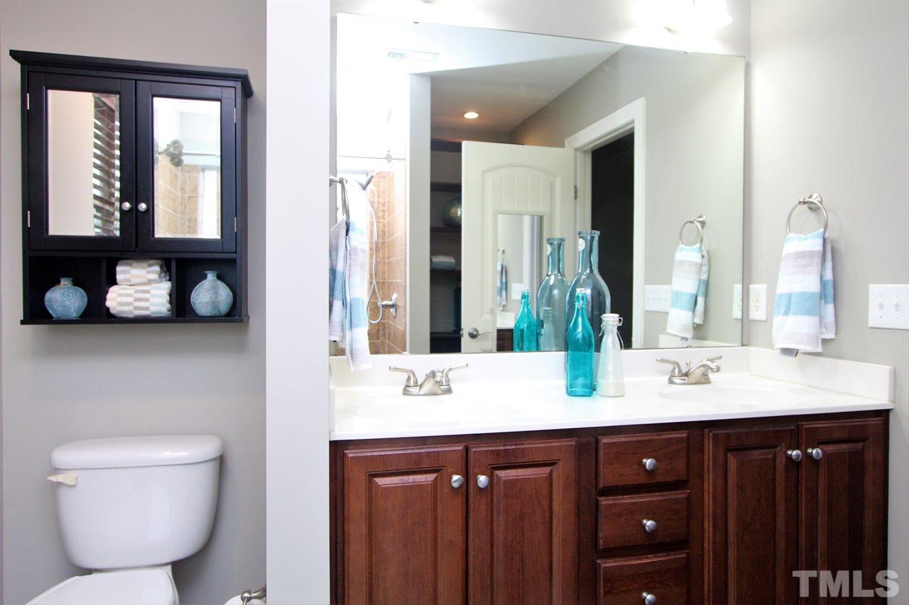 203 Orkney Road Stem, NC 27581 - Photo 18 of 30 a bathroom with a double vanity sink and a mirror