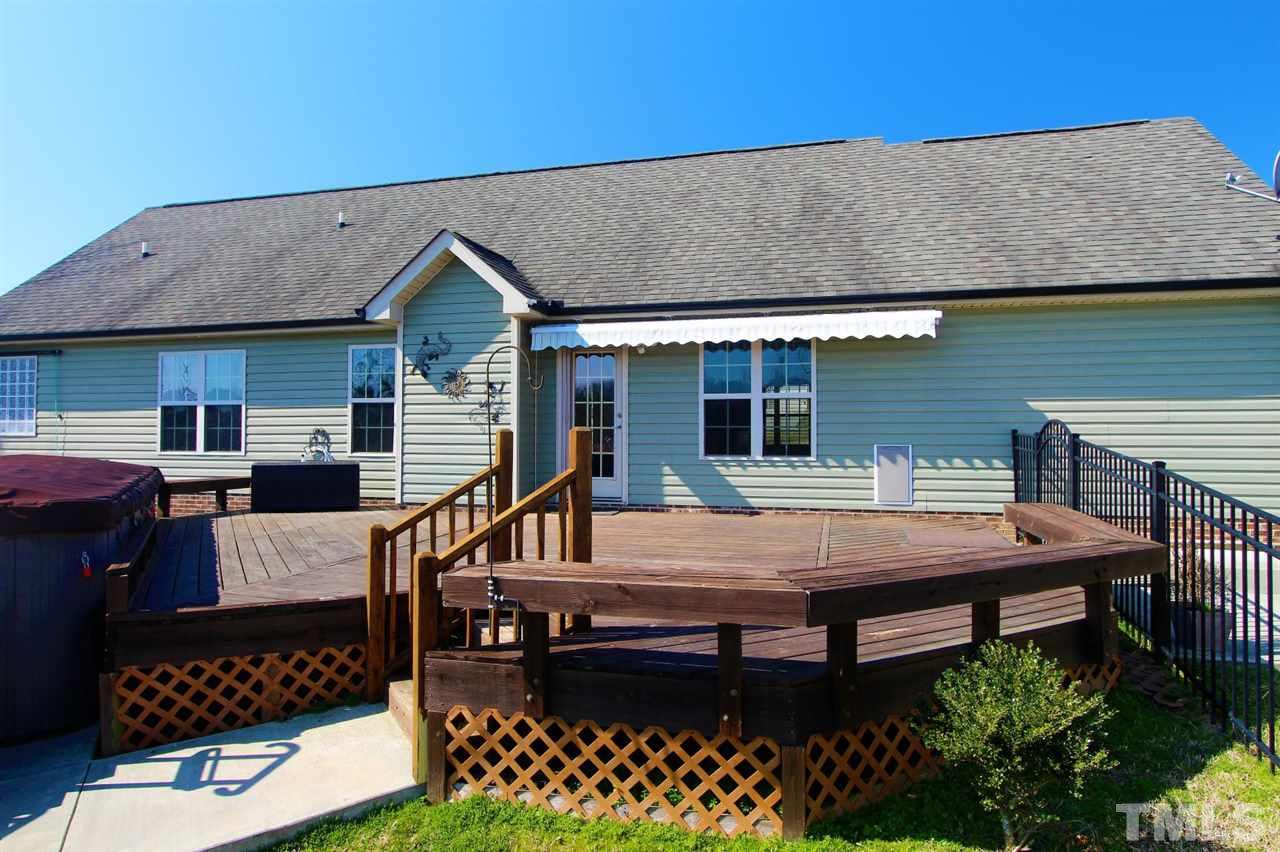 203 Orkney Road Stem, NC 27581 - Photo 26 of 30 a view of a patio with table and chairs with wooden floor and fence