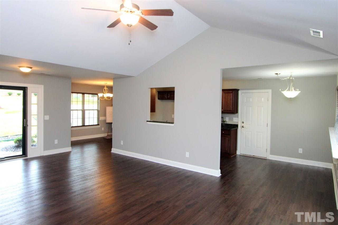 203 Orkney Road Stem, NC 27581 - Photo 6 of 30 a view of an empty room with window and wooden floor