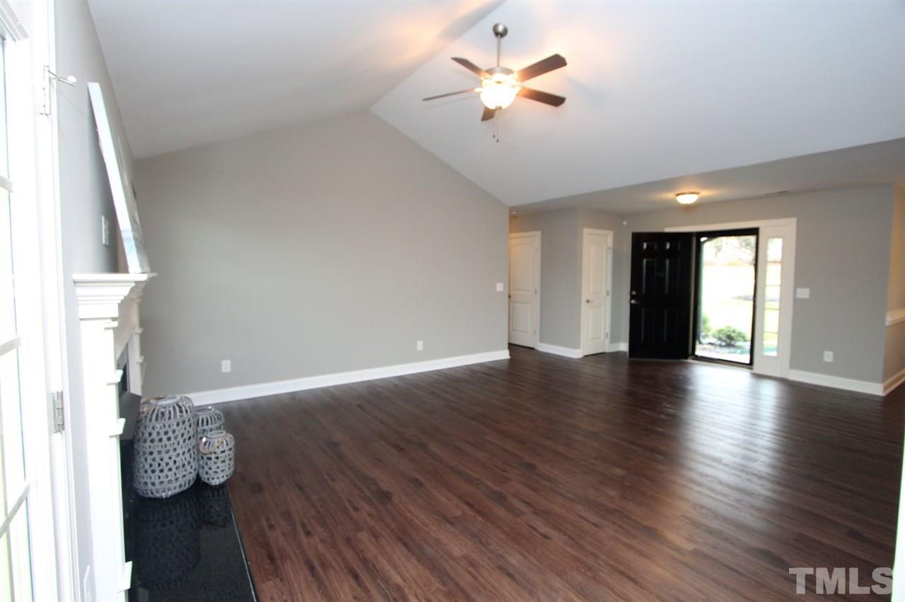 203 Orkney Road Stem, NC 27581 - Photo 7 of 30 an empty room with wooden floor and ceiling fan
