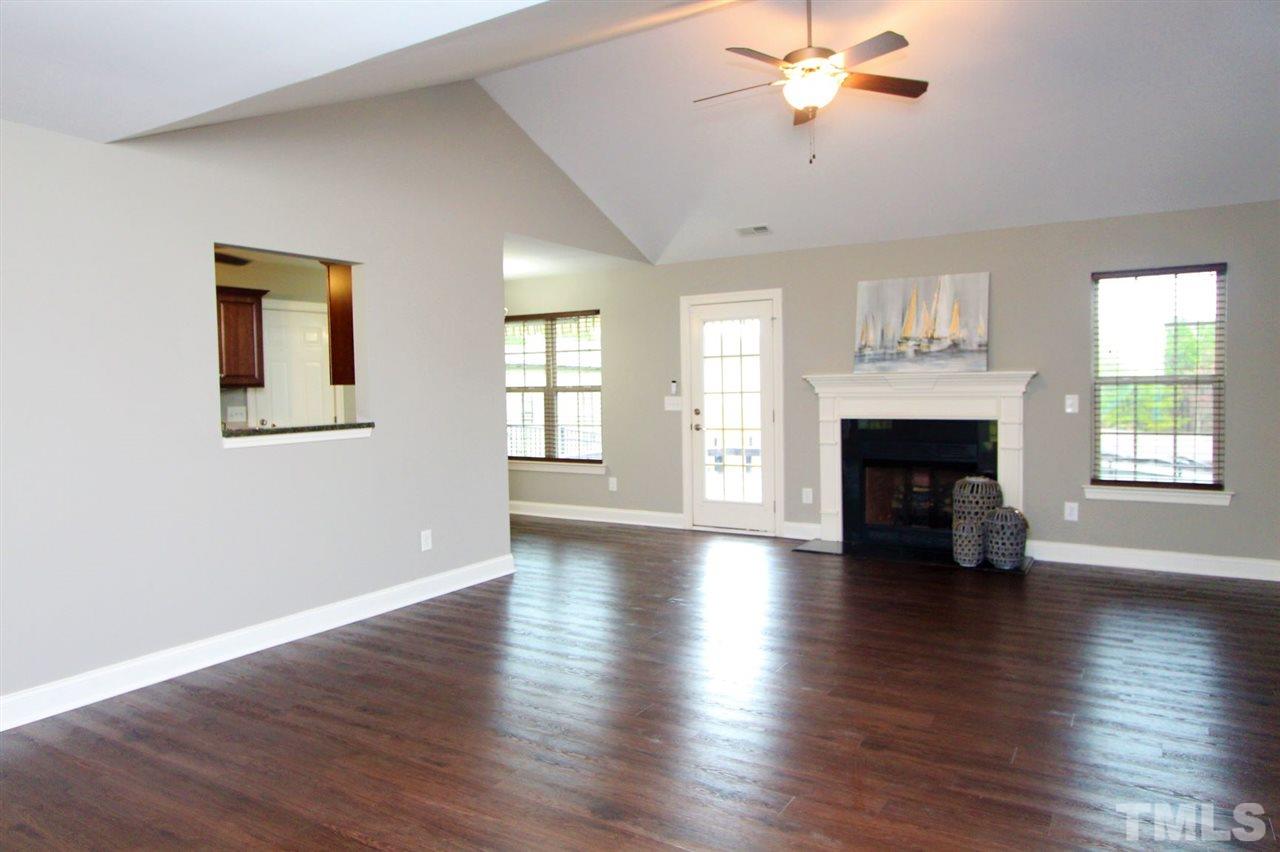 203 Orkney Road Stem, NC 27581 - Photo 8 of 30 wooden floor fireplace and windows in an empty room