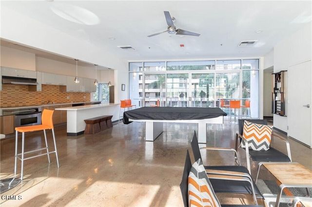 a living room with fireplace furniture and a large window