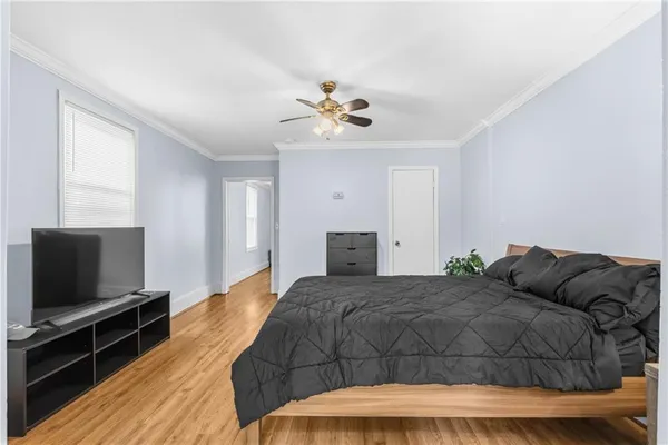 a living room with a bed and a chandelier