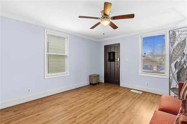 a living room with furniture and a potted plant