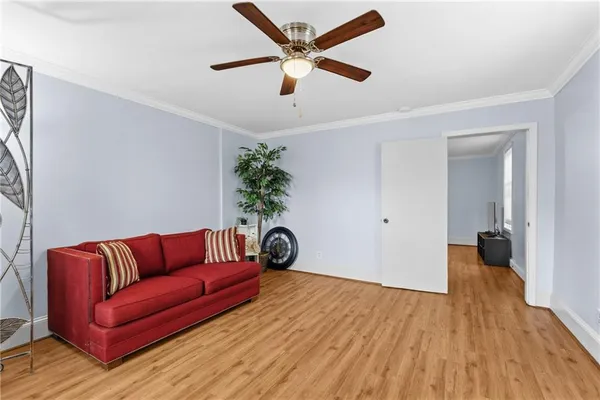 a view of a hallway with wooden floor and stairs