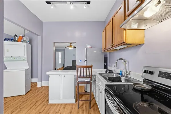 a kitchen with stainless steel appliances granite countertop a refrigerator and a stove top oven