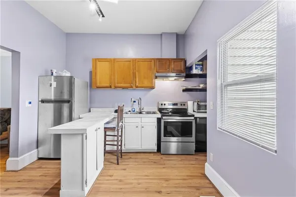 a kitchen with stainless steel appliances a stove a sink and cabinets