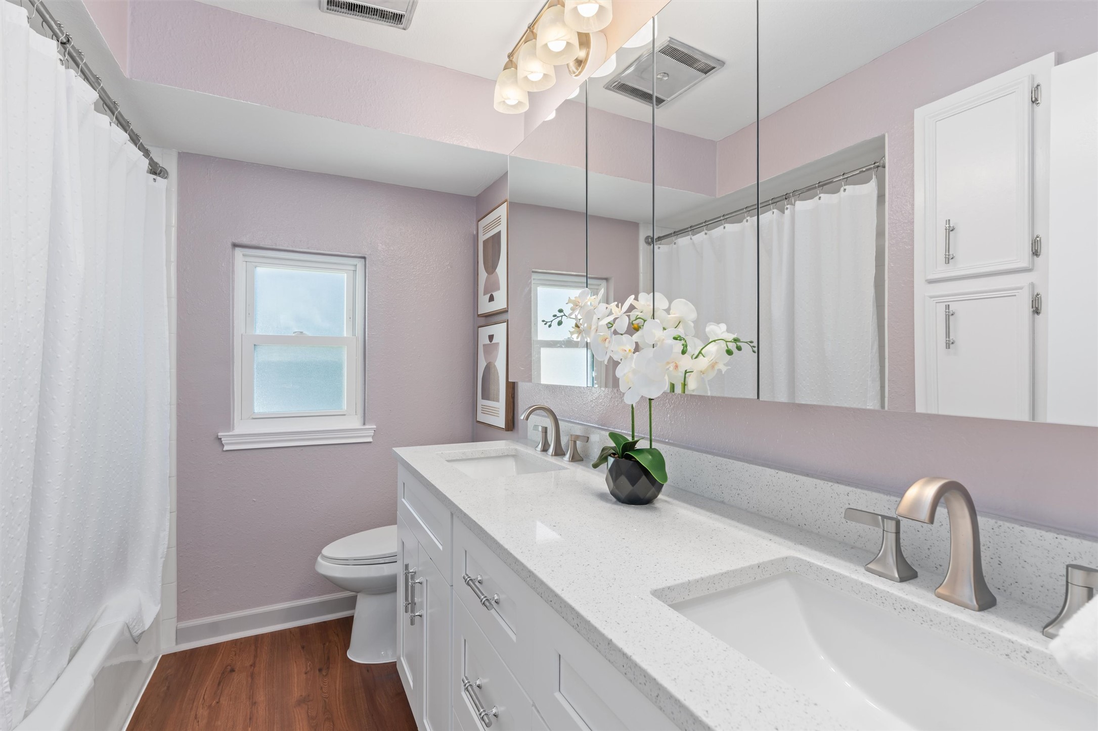 11902 Barrington Way Austin, TX 78759 - Photo 16 of 30 Primary bathroom with double vanity and dark wood-style flooring