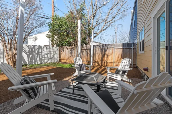 a view of a patio with couple of chairs and couches in the patio