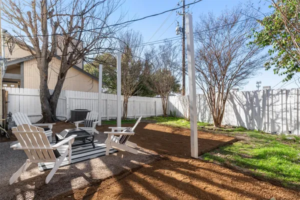 a view of a house with backyard and sitting area