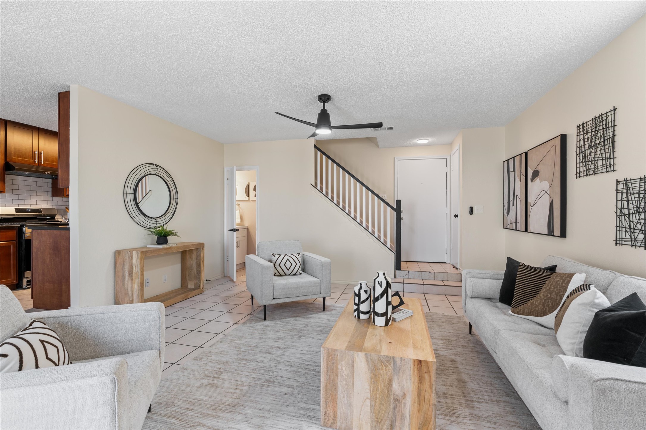 11902 Barrington Way Austin, TX 78759 - Photo 6 of 30 Living area featuring ceiling fan, a textured ceiling, and light tile patterned flooring