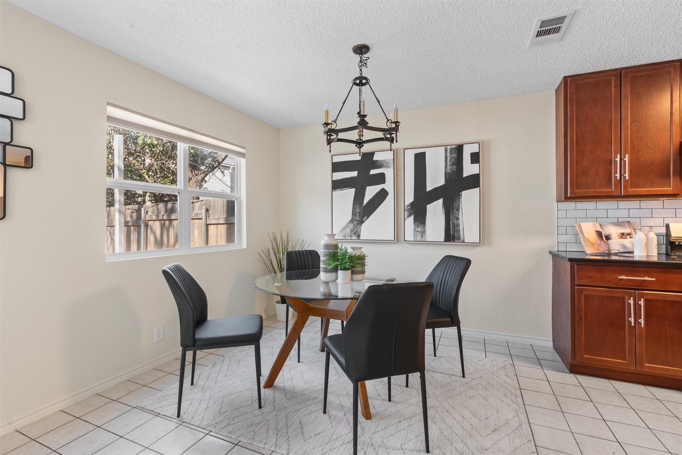 11902 Barrington Way Austin, TX 78759 - Photo 8 of 30 Dining space with a chandelier, light tile patterned flooring, and a textured ceiling