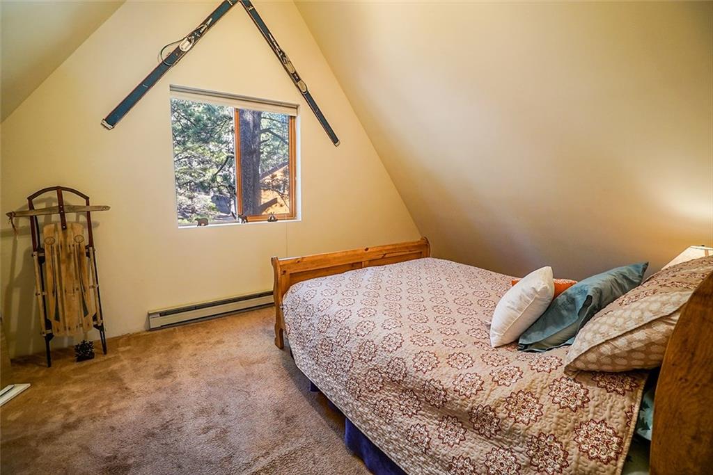 1276 South Crystal Road Lake George, CO 80827 - Photo 11 of 25 a bedroom with a bed and a window