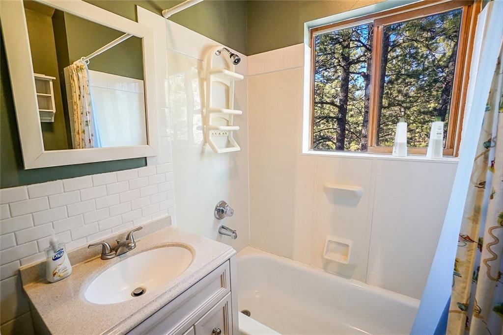 1276 South Crystal Road Lake George, CO 80827 - Photo 12 of 25 a bathroom with a sink and a bathtub