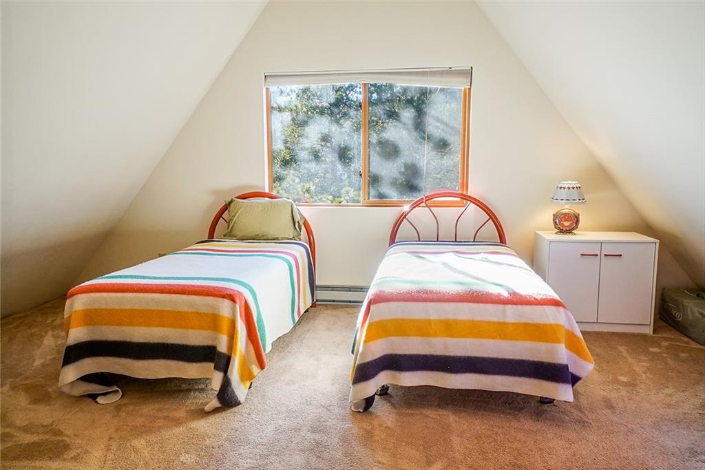 1276 South Crystal Road Lake George, CO 80827 - Photo 13 of 25 a bedroom with a bed and lamp