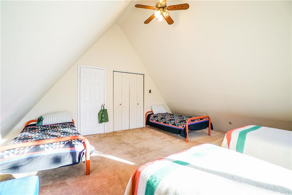 1276 South Crystal Road Lake George, CO 80827 - Photo 14 of 25 a bedroom with a bed and a chandelier