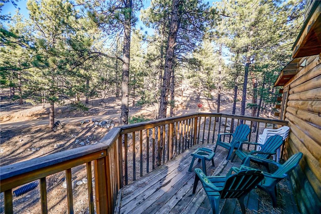 1276 South Crystal Road Lake George, CO 80827 - Photo 18 of 25 a view of balcony with wooden floor and outdoor seating