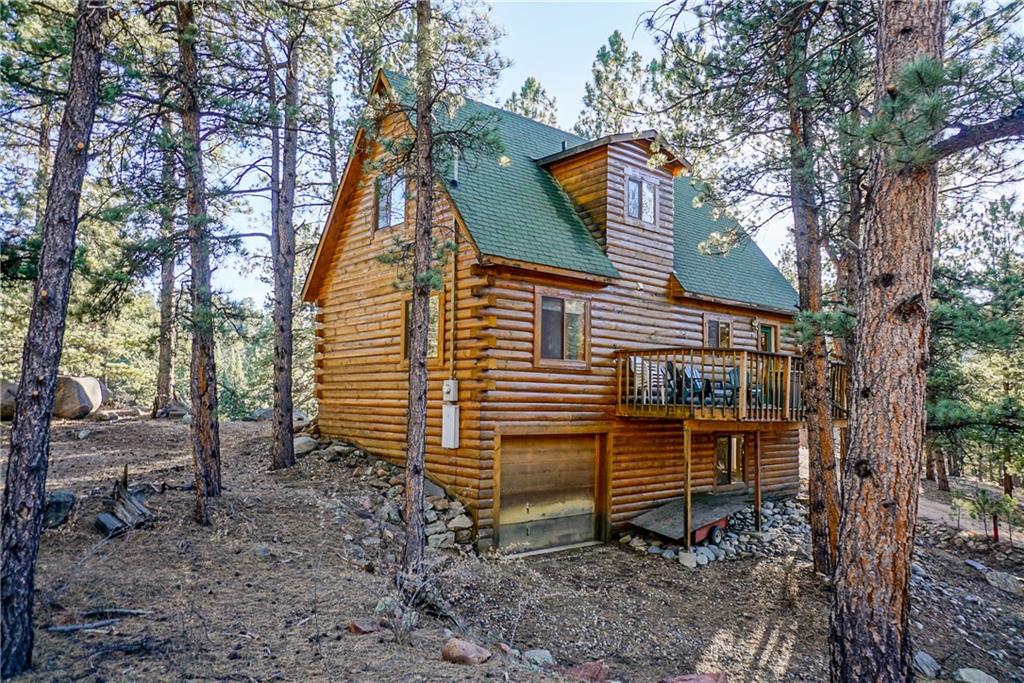 1276 South Crystal Road Lake George, CO 80827 - Photo 3 of 25 a backyard of a house with a bench and trees