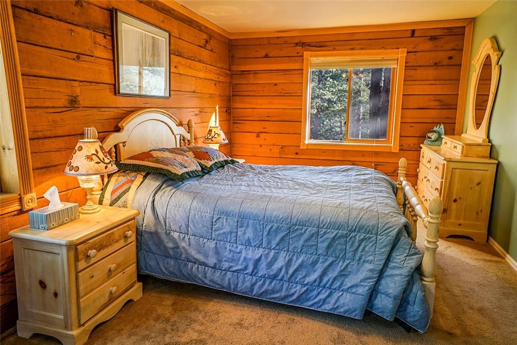 1276 South Crystal Road Lake George, CO 80827 - Photo 10 of 25 a bedroom with a bed and wooden floor