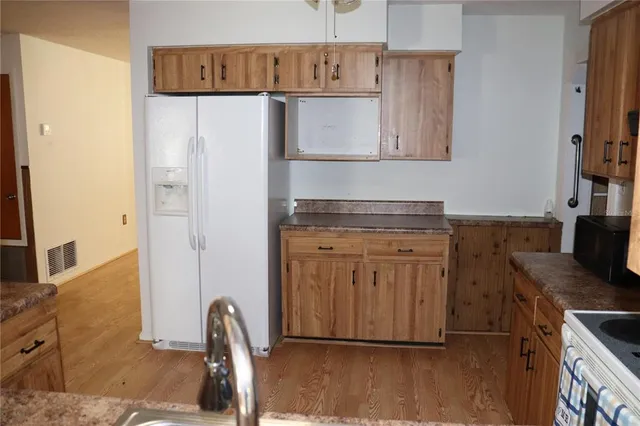 a kitchen with a refrigerator and a stove